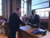 Pieter Roden receives his diploma from Chibuike Uche from the Board of Examiners; in the back Mayke Kaag, director of Studies at the ASCL.